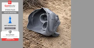 A gray 3D-printed replica of a giant characin fish skull on sandy ground.