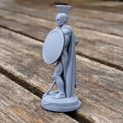 3D-printed Spartan warrior model holding shield and spear, wearing a cape and helmet.