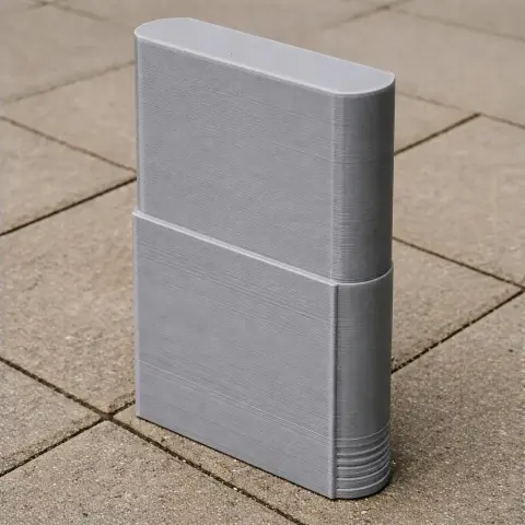3D printed model of a rectangular skyscraper with rounded edges, on a tiled surface.