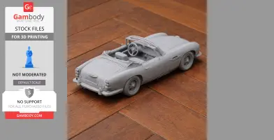 3D printed model of a classic Aston Martin DB5 car, detailed interior, on a wooden surface.