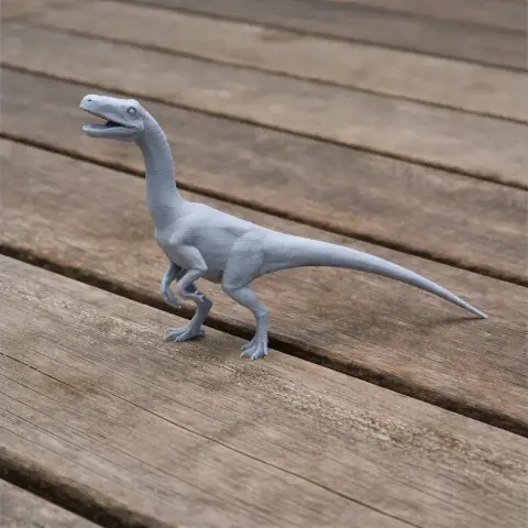 Gray 3D-printed model of a Segisaurus dinosaur standing on a wooden surface.