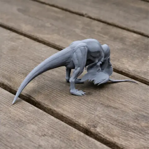 Gray 3D-printed model of Shaochilong dinosaur on wooden surface.