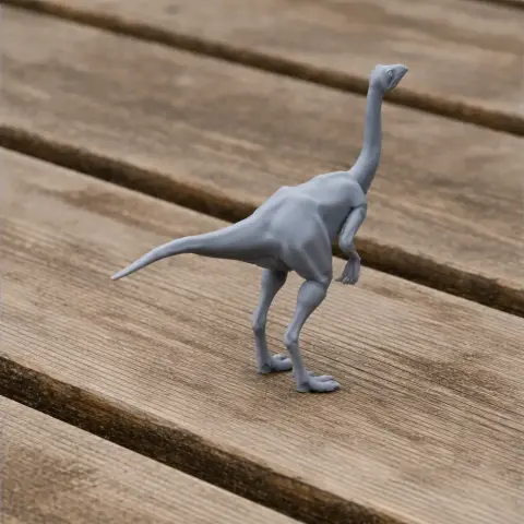 A 3D-printed model of a Struthiomimus dinosaur on a wooden surface.