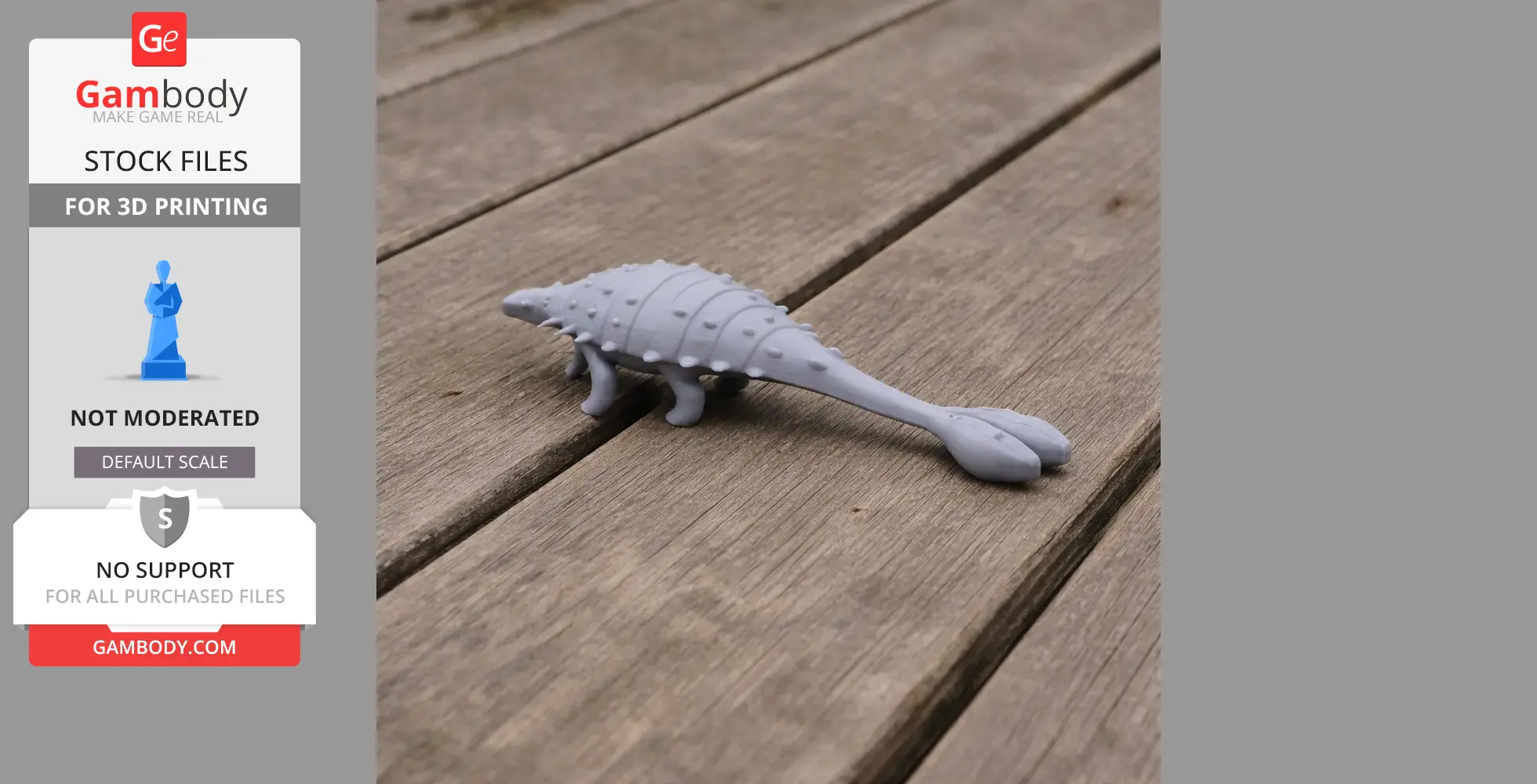 A gray 3D-printed model of a Tarchia dinosaur on a wooden surface.