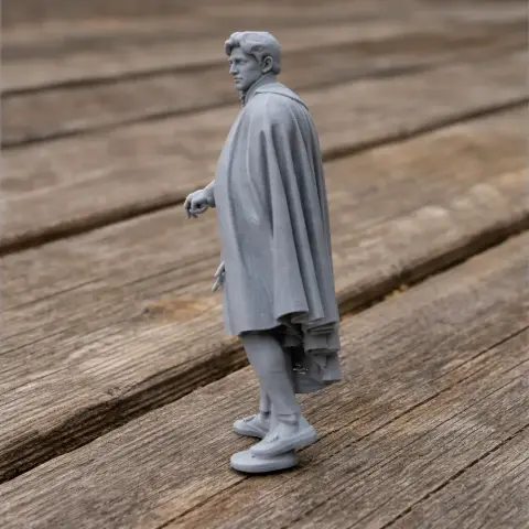 A 3D-printed model of a Napoleonic soldier in a cloak, standing on a wooden surface.