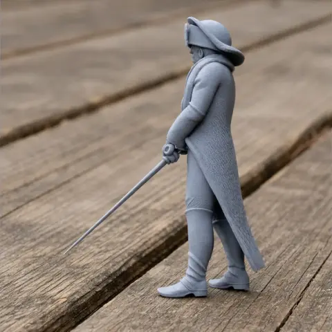 3D printed Napoleonic soldier model in uniform, holding sword, standing on wooden surface.