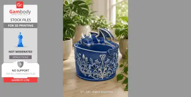 A blue dragon draped over a decorative bowl with floral designs, surrounded by indoor plants.