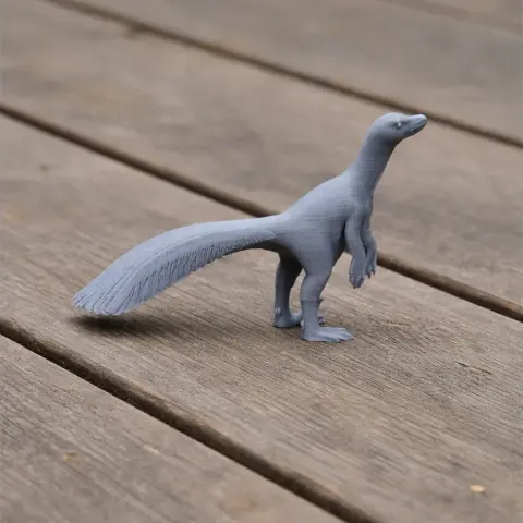 A 3D printed model of Tsaagan, a small prehistoric dinosaur, on a wooden surface.