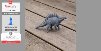 A 3D-printed gray model of a Tuojiangosaurus with distinctive back spikes, displayed on a wooden surface.