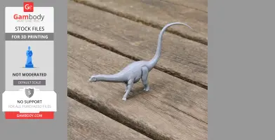 Gray 3D-printed model of a long-necked dinosaur on a wooden surface.