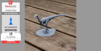 Gray 3D-printed dinosaur model, Valdoraptor, on a wooden surface.