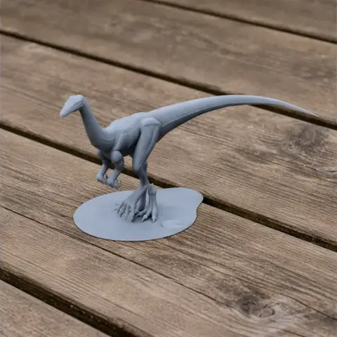 A 3D printed model of a Valdoraptor dinosaur on a wooden surface.