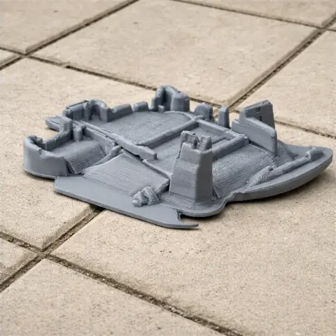 A 3D-printed model of Helmsley Castle with towers and walls, displayed on a tiled surface.