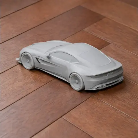 3D printed model of a 2018 Aston Martin Vantage on a wooden floor.