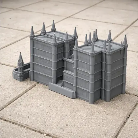 Gray 3D-printed model of Lincoln Cathedral with detailed towers on a tiled surface.