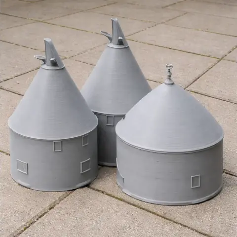 Three 3D-printed conical oast houses with square windows and distinct roofs, placed on a tiled surface.