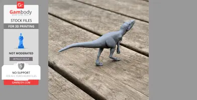 Gray 3D printed dinosaur model with a long tail, standing on wooden planks.