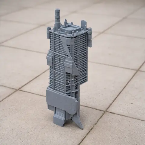 A detailed 3D-printed architectural model of a tall, modern building with intricate facade elements.