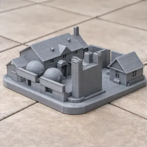 A detailed 3D-printed model of a building complex with domes, chimneys, and various structures.
