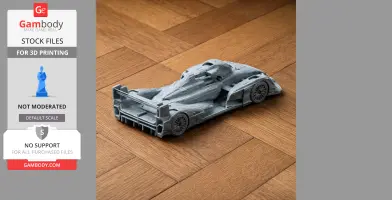 A detailed 3D-printed model of an Audi R15 TDI race car on a wooden floor.