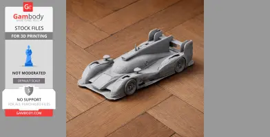 Gray 3D-printed Audi R18 model car on wooden flooring.