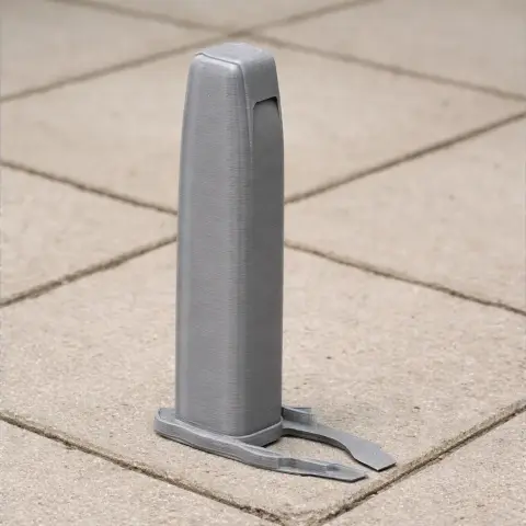 A gray, minimalist architectural 3D printed model on a tiled surface.