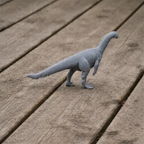 Gray 3D-printed Yunnanosaurus model on a wooden surface.