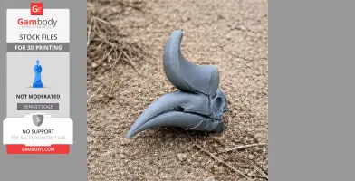 A 3D printed rhinoceros hornbill skull replica on sandy ground.