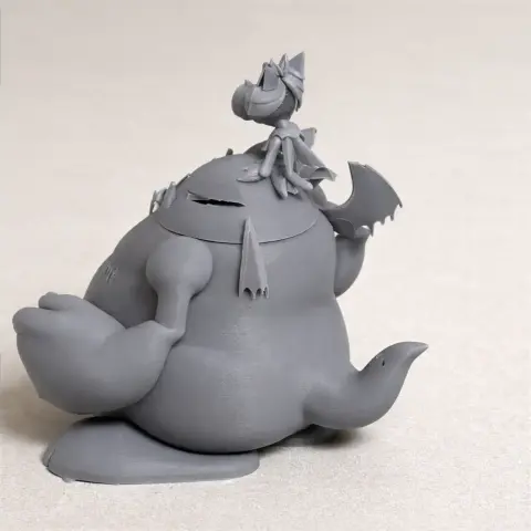 A whimsical creature figure with a seated character on top, featuring large hands and a tail.