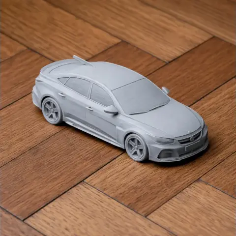 3D-printed scale model of an Audi RS5 car on a wooden surface.