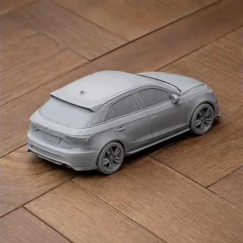 3D printed scale model of an Audi S1 car on a wooden surface.
