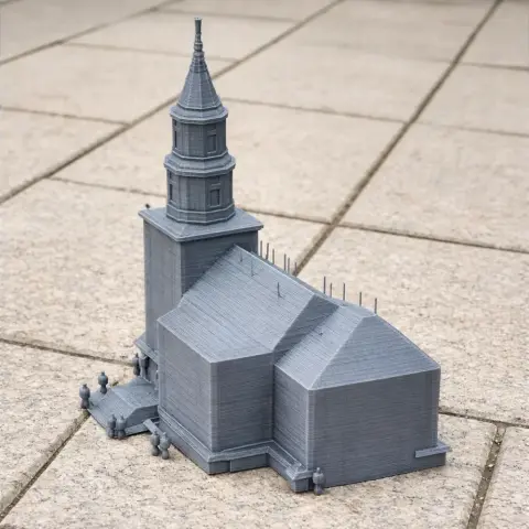 3D-printed model of a parish church with a tall steeple and detailed architectural features.