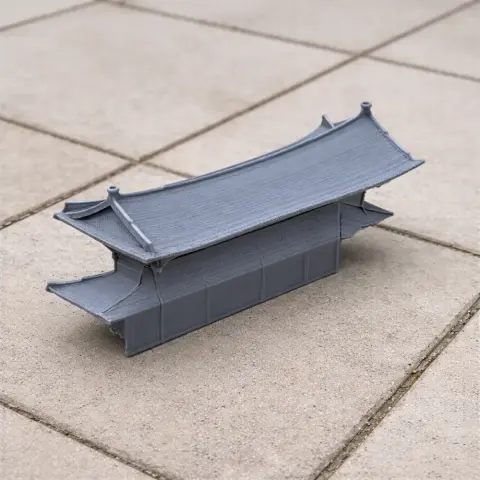 A 3D-printed model of a traditional Korean building with a curved, tiered roof.