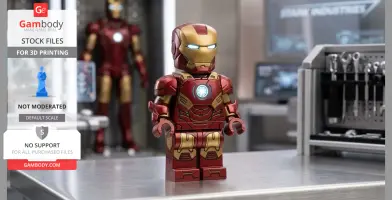 A Lego-style red and gold armor figure on a workshop table, with tools and screens in the background.