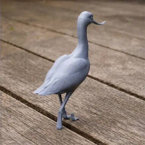Gray 3D-printed model of an avocet bird standing on wooden planks.