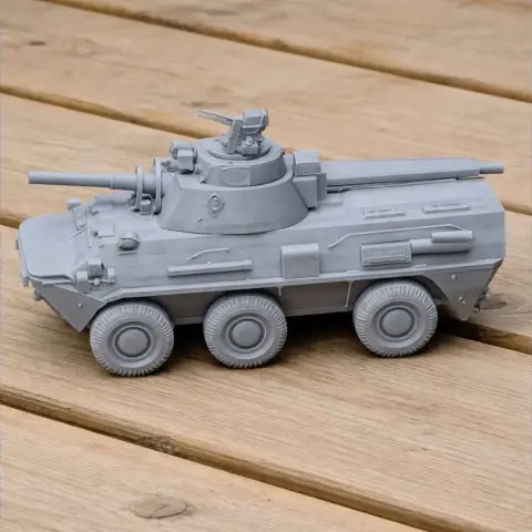3D printed model of a 2S23 Nona-SVK tank with detailed turret and wheels on a wooden surface.
