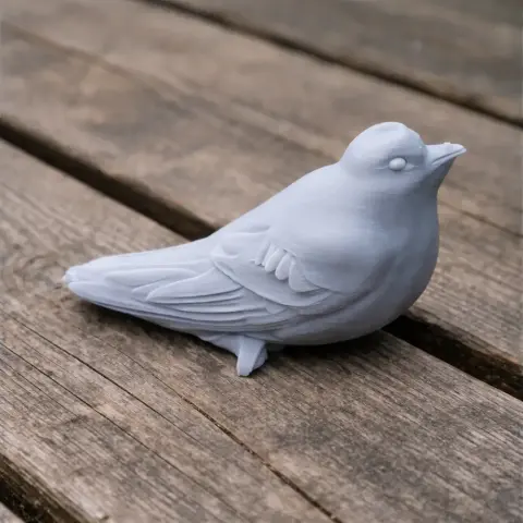 3D printed model of a bird, resembling an American black swift, on a wooden surface.
