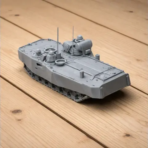 Gray 3D-printed AAVP7 tank model with detailed tracks and top structures, on a wooden surface.