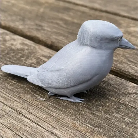 3D printed model of a bird, resembling a kingfisher, in a gray plastic material.