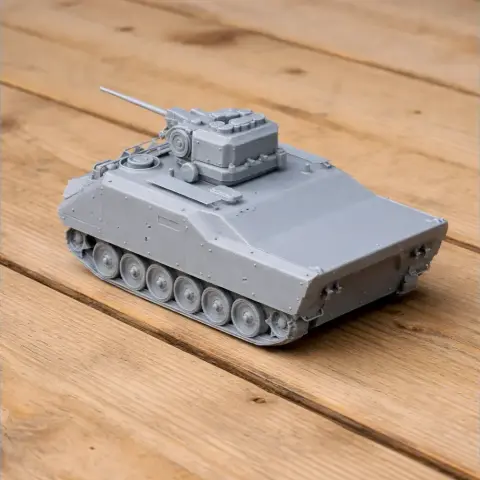 Gray 3D-printed Armored Infantry Fighting Vehicle model with a turret on a wooden surface.