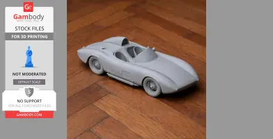 Gray scale model of a vintage Bandini race car, shown on a wooden floor.