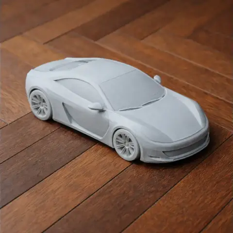 3D printed scale model of a Bertone Birusa car, unpainted, on a wooden surface.