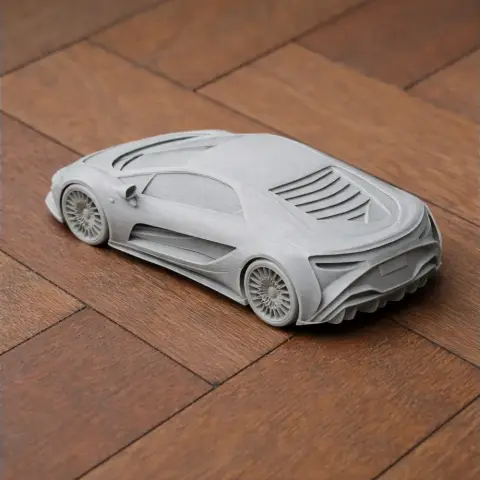 3D printed model of a sleek sports car, viewed from the rear on a wooden surface.