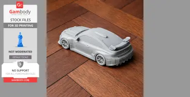 3D printed BMW M2 racing model in gray, displayed on wooden flooring.