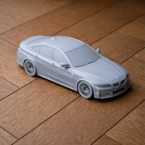 3D printed model of a BMW M3 car, featuring detailed design, on a wooden surface.