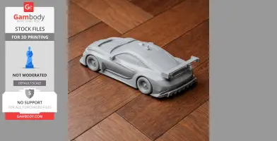 Miniature 3D-printed BMW M6 GTLM car model, shown on a wooden surface.