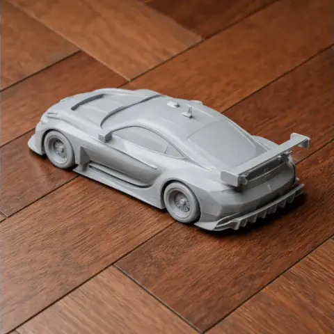 3D printed model of a BMW M6 GTLM race car on a wooden surface.