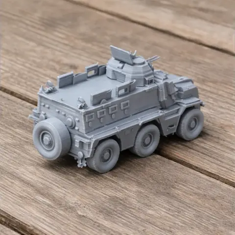 Gray 3D-printed armored military vehicle model with six wheels and turret, on wooden surface.
