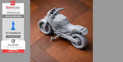 Gray 3D-printed BMW R1250GS motorcycle model resting on wooden surface.
