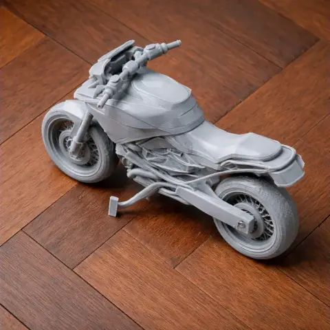 3D printed model of a BMW R1250GS motorcycle on a wooden surface.